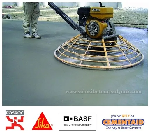 Aplikasi floor hardener dengan trowel pada beton segar